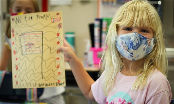 Girl holds up Constitution craft